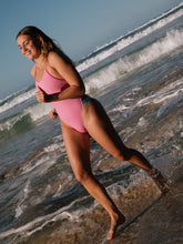 Athlete wearing the IBIZA chlorine resistant one piece designed by JAYD Swimwear. Featured colour is Fairy floss with contrasting hip cut outs and shoulder straps.